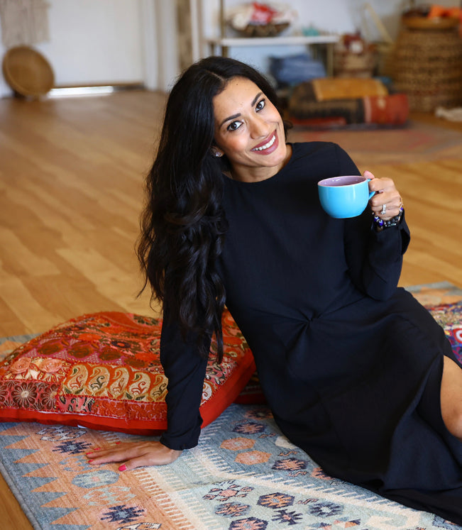 Woman enjoying a warm cup of elderberry tea for immune support