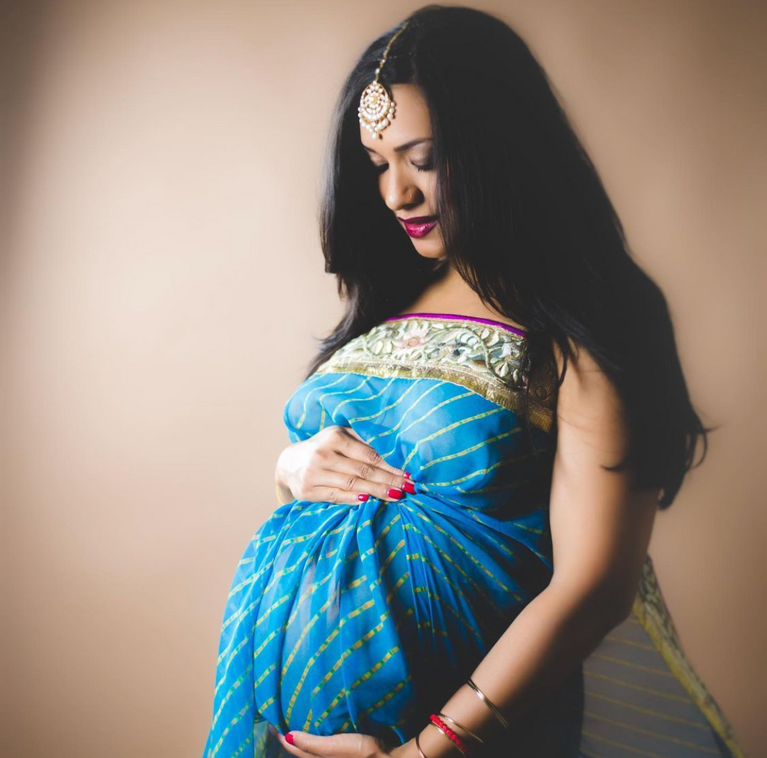Pregnant woman drinking elderberry syrup for immune support in Arizona