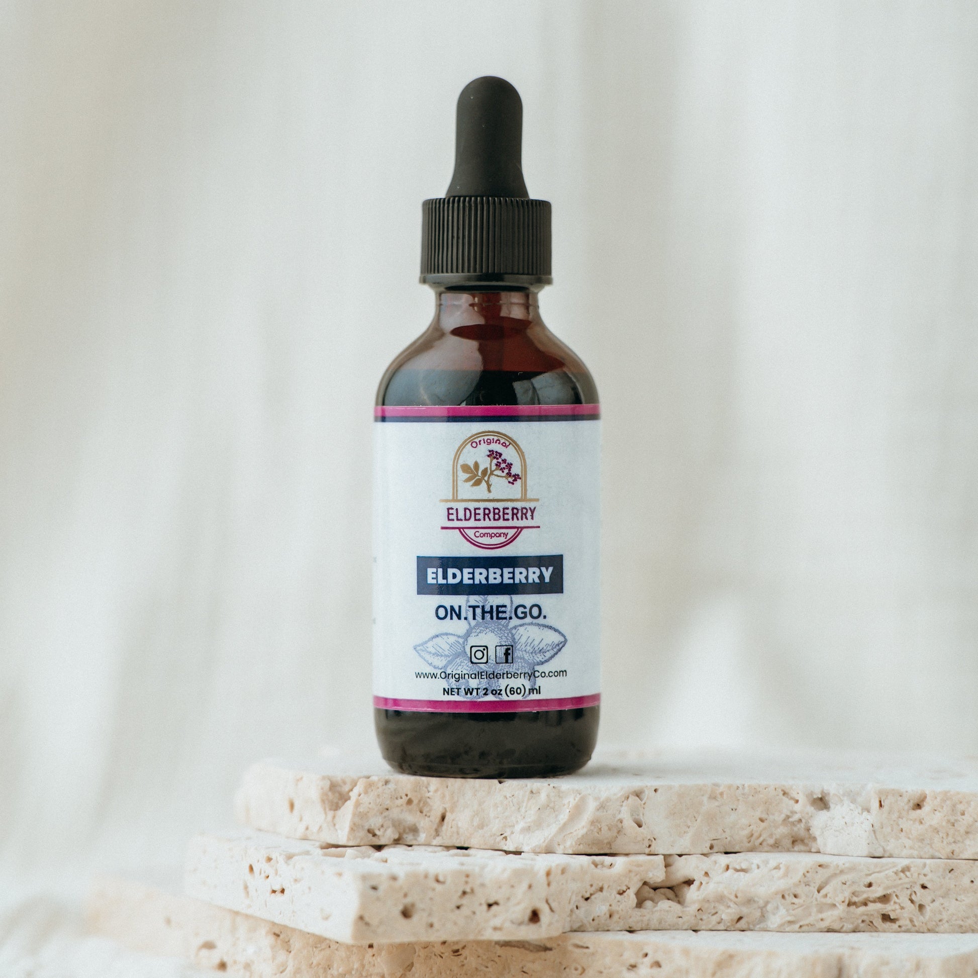 Bottle of Elderberry on the Go with a dropper on a light background